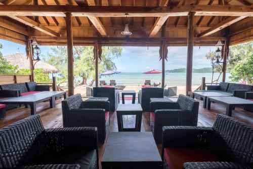 a restaurant with chairs and tables on the beach at Sol Beach Resort in Koh Rong Sanloem