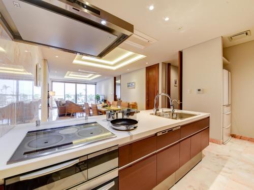 a kitchen with a sink and a counter top at Ishigaki Resort Hotel in Ishigaki Island