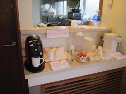 a kitchen counter with a coffee maker on a shelf at Jemsty Inn Hakone Ashinoko in Hakone