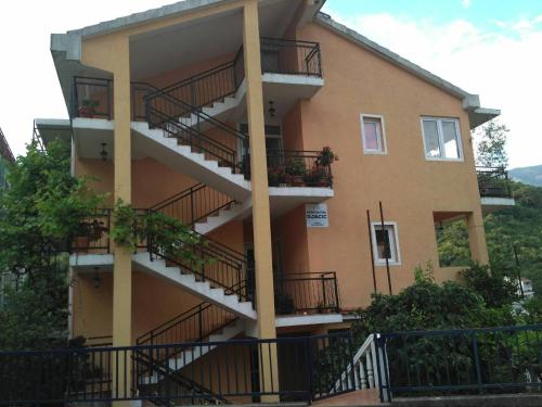 a building with balconies and plants on it at Guesthouse Djacic in Budva
