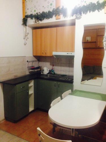 a kitchen with a table and a white table and chairs at Ski apartmány Spiežovec Donovaly in Donovaly