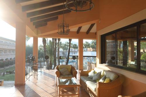 a living room with a couch and chairs on a patio at Mon Port Hotel & Spa in Port d’Andratx