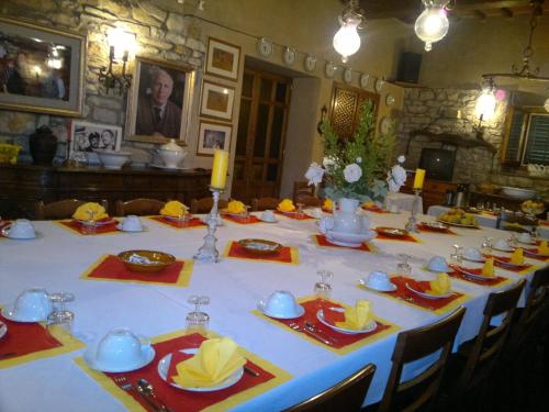 a table with a white table cloth and yellow napkins at La Fattoressa in Florence