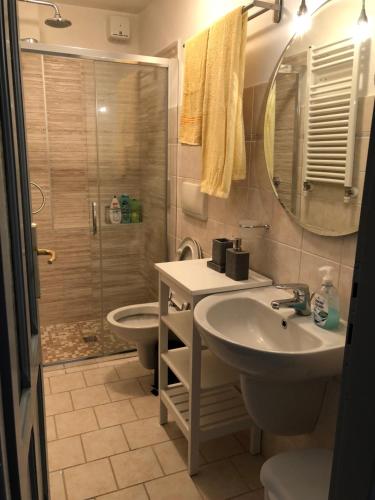 a bathroom with a sink and a shower and a toilet at Villa Angela in Bellagio