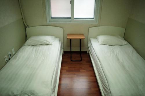 Ένα ή περισσότερα κρεβάτια σε δωμάτιο στο YaKorea Hostel Gangnam