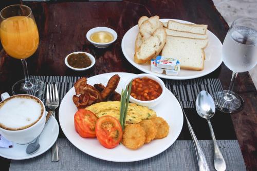 a table with two plates of breakfast food and drinks at Long Set Resort in Koh Rong Island