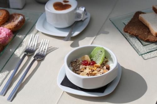 a table with a bowl of cereal and a cup of coffee at Mon Port Hotel & Spa in Port d’Andratx