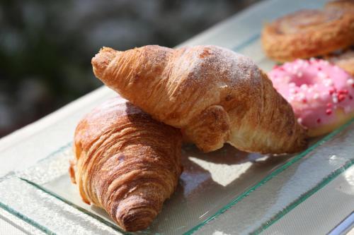a croissant and a donut on a plate at Mon Port Hotel & Spa in Port d’Andratx