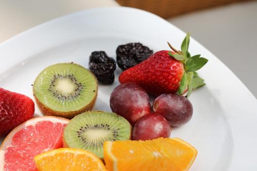a plate of fruit on a white plate at Mon Port Hotel & Spa in Port d’Andratx