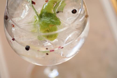 a wine glass with a green object in it at Mon Port Hotel & Spa in Port d’Andratx