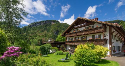 a house in the middle of a garden at Gschwenderhaus Ferienwohnungen in Oberstdorf
