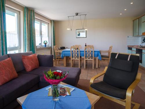 a living room with a couch and a table at Am Maiglöckchenberg 19 in Ostseebad Karlshagen