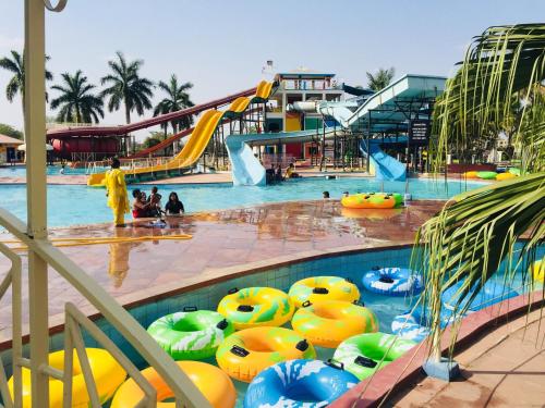 a large swimming pool with a water park with a water slide at Hotel Kanha’s Palm Springs in Bhopal