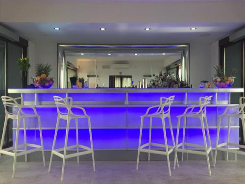 a blue bar with stools in a room at Corte Ongaro Hotel in Verona