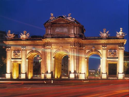 a large building with lights on it at night at AYZ Juan de Mena - Auto check-in property in Madrid