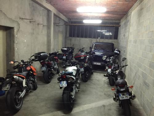 a row of motorcycles parked in a garage with a car at Le Signoret in Sault-de-Vaucluse