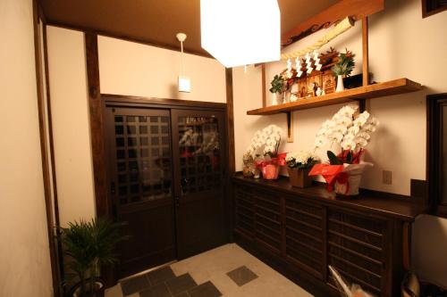 
a living room filled with furniture and decorations at HOSTEL MICHIKUSA-YA in Fujikawaguchiko
