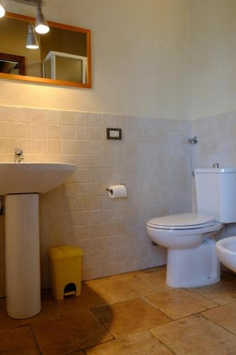 a bathroom with a white toilet and a sink at Canto De' Bacci in Foiano della Chiana