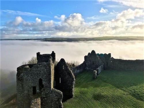 an old castle in the middle of a fog covered field at Corner Cwtch in Llanstephan