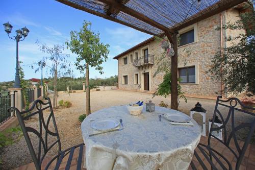 a table with a white table cloth on a patio at Casale Madeccia in Sonnino