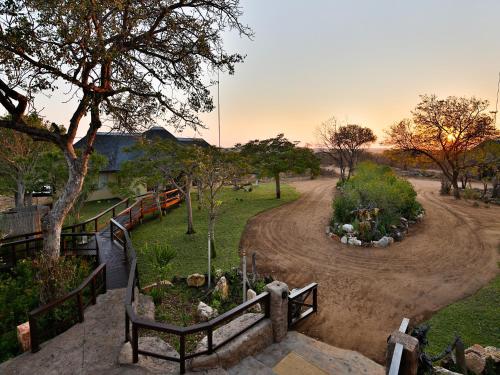 a garden with a dirt road in a park at Makumu Private Game Lodge in Klaserie Private Nature Reserve