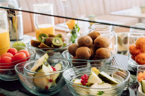 a table topped with bowls of fruits and vegetables at Chic & Basic Velvet in Barcelona