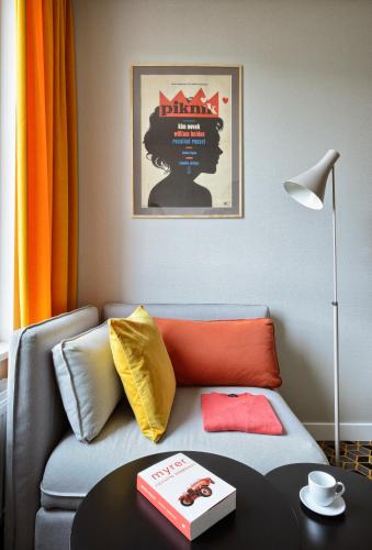 a living room with a couch and a table at Arche Hotel Poloneza in Warsaw