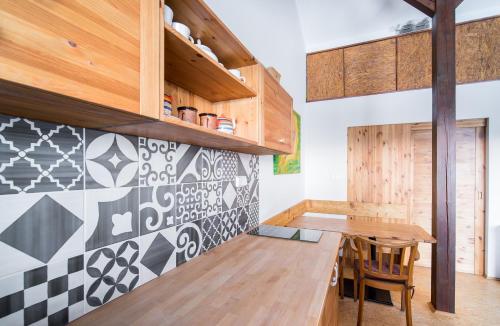 a kitchen with a wooden table and wooden cabinets at Refugio in Tisá