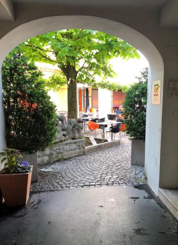 an archway leading to a patio with a tree at Best Place Apartments Vienna in Vienna