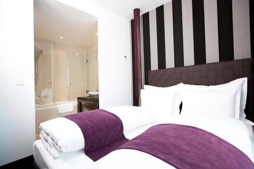 a hotel room with two beds and a bathroom at Goodman's Living in Berlin