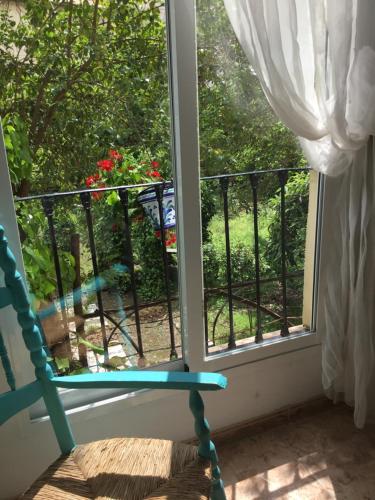 a blue rocking chair sitting in front of a window at San José Guest House in Granada