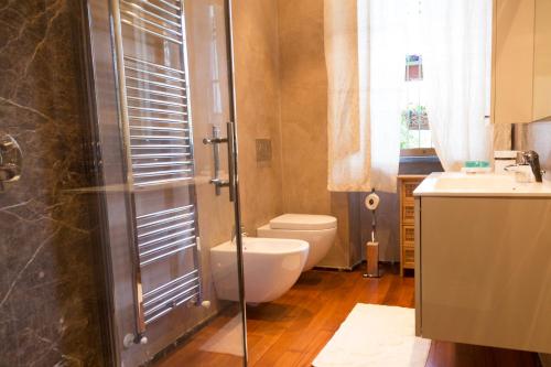 a bathroom with a toilet and a sink and a shower at La Querciolaia B&B in Massa