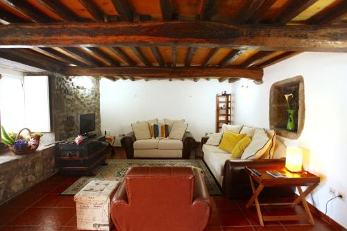 a living room with a couch and a table at Casa da Roseira in Nordeste