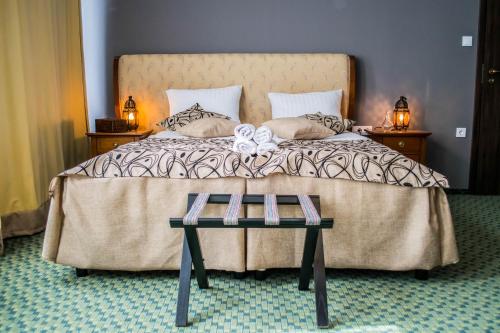 a bedroom with a bed with two books on it at Petra Hotel in Nyíregyháza