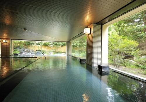 a house with a pool of water in a room at Higashiyama Park Hotel Shinfugetsu in Aizuwakamatsu
