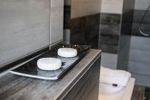 two towels on a tray on a counter in a bathroom at Petra Hotel in Nyíregyháza