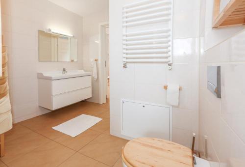 a white bathroom with a sink and a mirror at NIKA Pokoje u Weroniki in Władysławowo