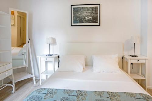 a bedroom with a white bed and two night stands at Apartment Marinis in Split