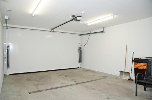 an empty room with a white wall and a lamp at Chalet Rivendell - GRIWA RENT AG in Grindelwald