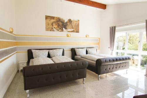 a living room with two beds and a couch at Rust-Fewo-Hotel in Rust