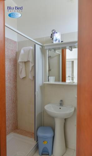 a bathroom with a shower and a toilet and a sink at Blu Bed Salento in Torre Lapillo