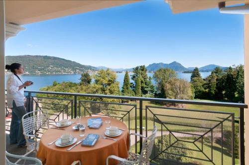 a table on a balcony with a view of the water at Residence Carl&Do in Baveno