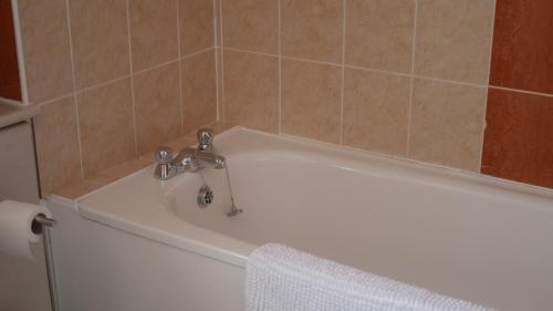 a white bath tub with a faucet in a bathroom at The Keep in Ludlow