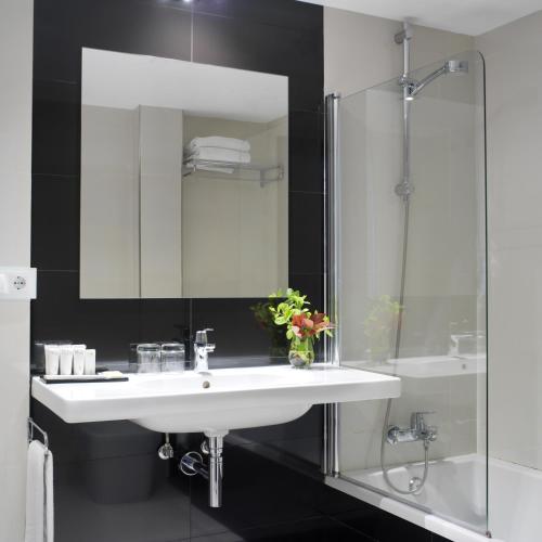 a bathroom with a white sink and a shower at Hotel Villa Rosario II, Edificio Moderno in Ribadesella