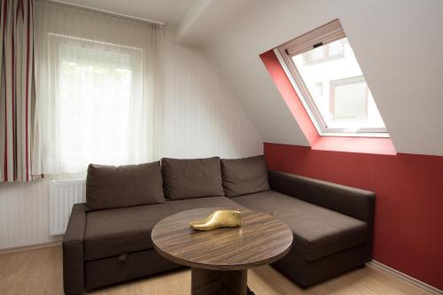 a living room with a couch and a table at Landhotel Wolfschlugen in Wolfschlugen