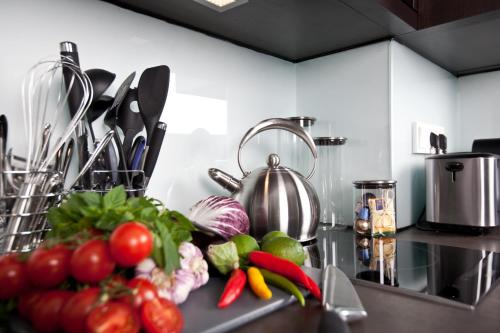 a kitchen counter with vegetables and a tea kettle at Goodman's Living in Berlin