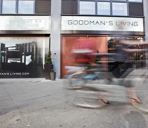 a person riding a bike in front of a store at Goodman's Living in Berlin