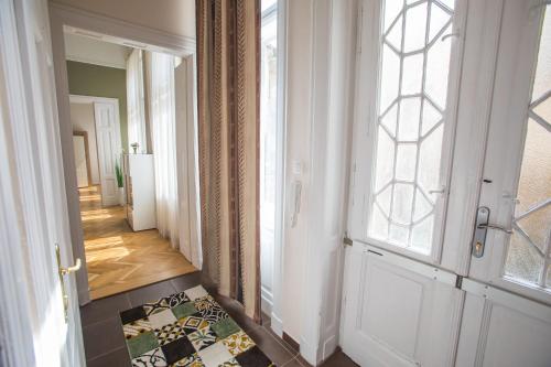 a hallway with a door and a window and a rug at Novák apartman Szeged in Szeged