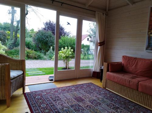 a living room with a couch and a large glass door at Ferienhaus Kaiser in Branchewinda