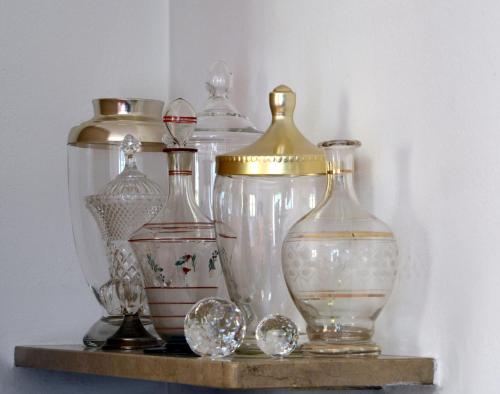 a group of glass vases sitting on a shelf at APARTMENT im garten 9 in Gargazzone